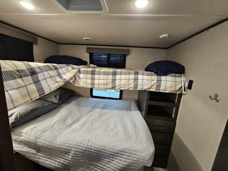 The back room with bunk beds. sleeps 4 comfortably. Top 2 beds are twin sized while the bottom bed is a full sized.