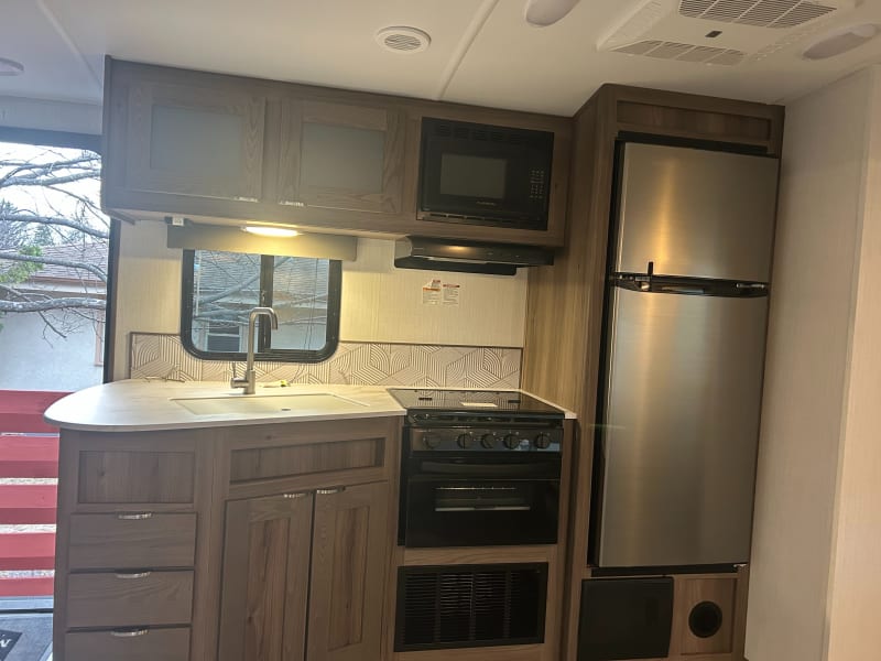 The kitchen provides ample room for meal preparation and cooking options include: a three burner stove, oven, and microwave. 

Outdoor kitchen includes: griddle, fridge, and cabinet space. 