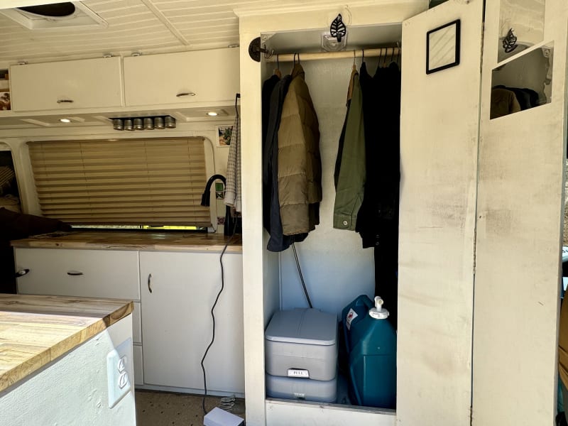 This is the portable toilet, the small grey box next to the spare water jug. 