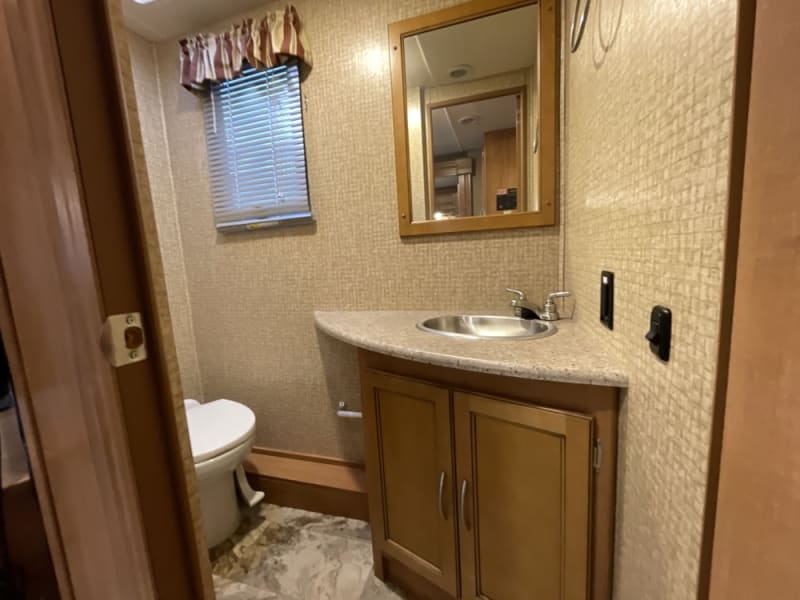 Half-bath located between kitchen area and the bedroom