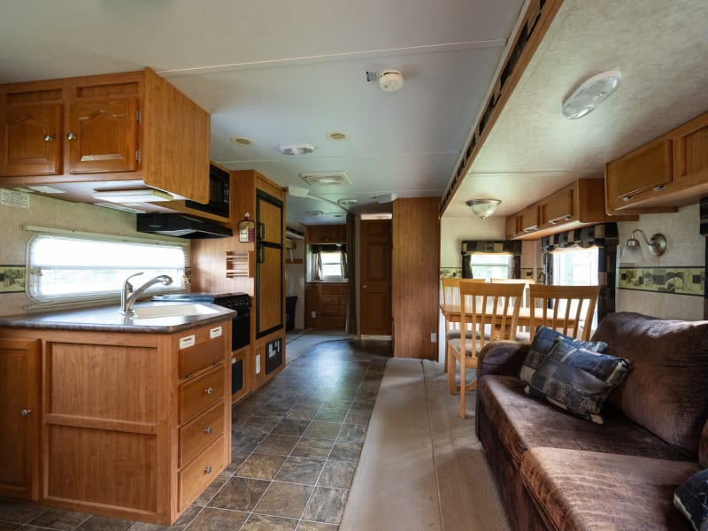 Main living area includes kitchen and living space. Sofa folds out into air bed to expand sleeping from 5 to 7. 