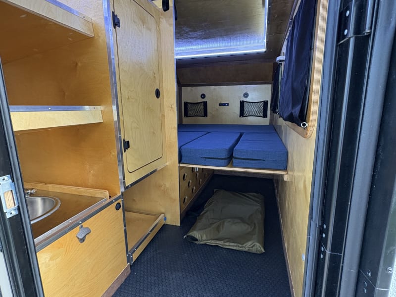 Interior of main cabin in bed configuration with tent access closed. 