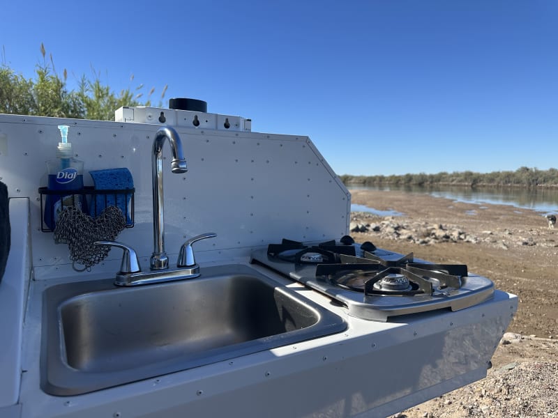 Propane dual cooktop. Sink with hot and cold water.