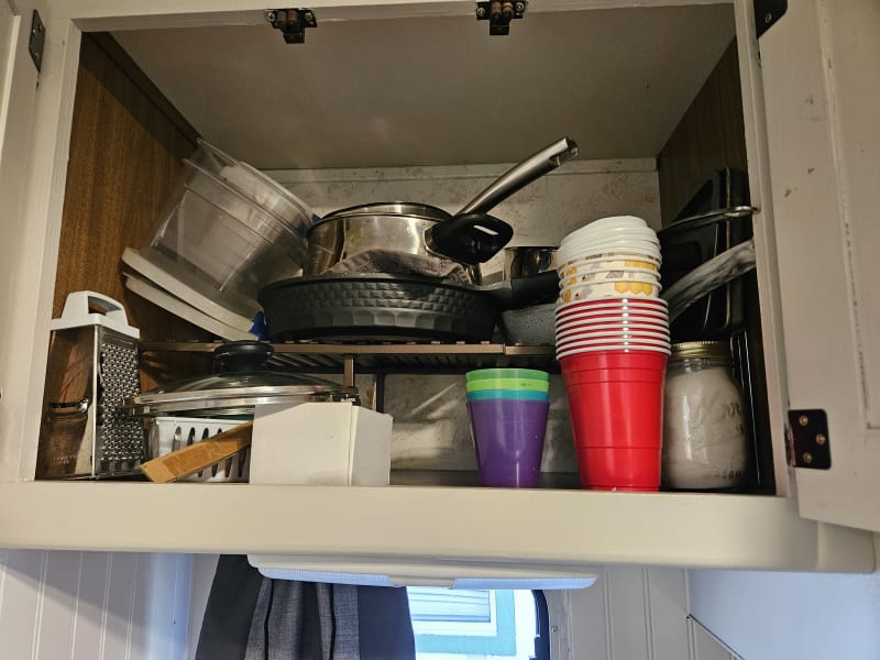 Pots and pans,cheese grater above kitchen sink