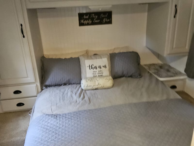 Queen bed has 12v cigarette lighter in back so you can put a phone charger. Lights above the bed