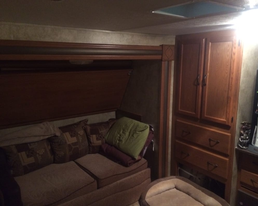 This the left side of the bunkhouse. As you can see the full size couch that converts to a queen size bed. Above the couch is a pull down bunk for any size or could be used for storage.