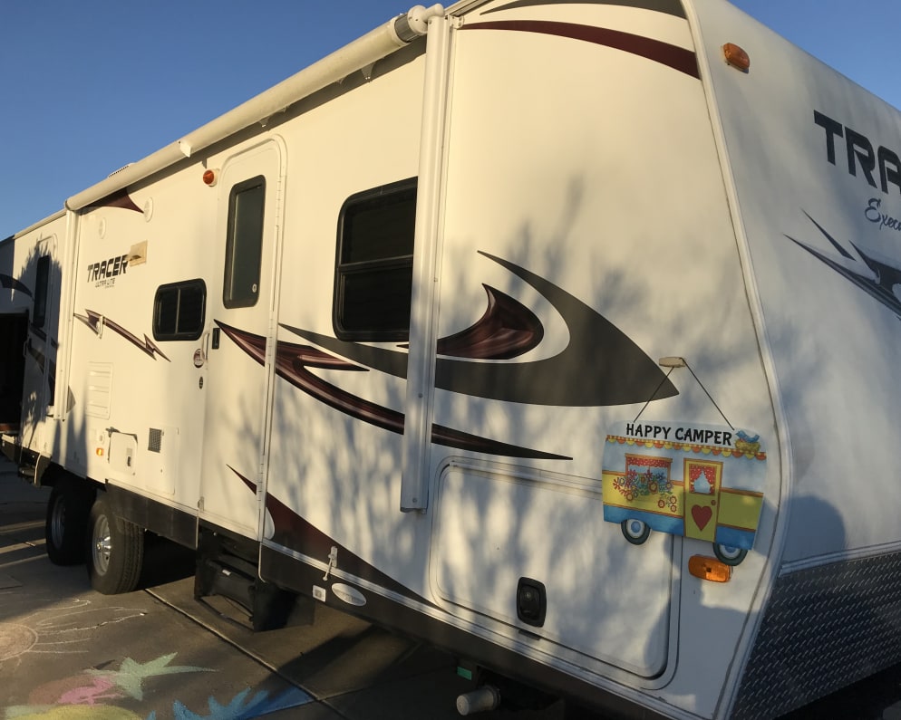 Front storage, outside kitchen with refrigerator and grill, electric retractable awning.