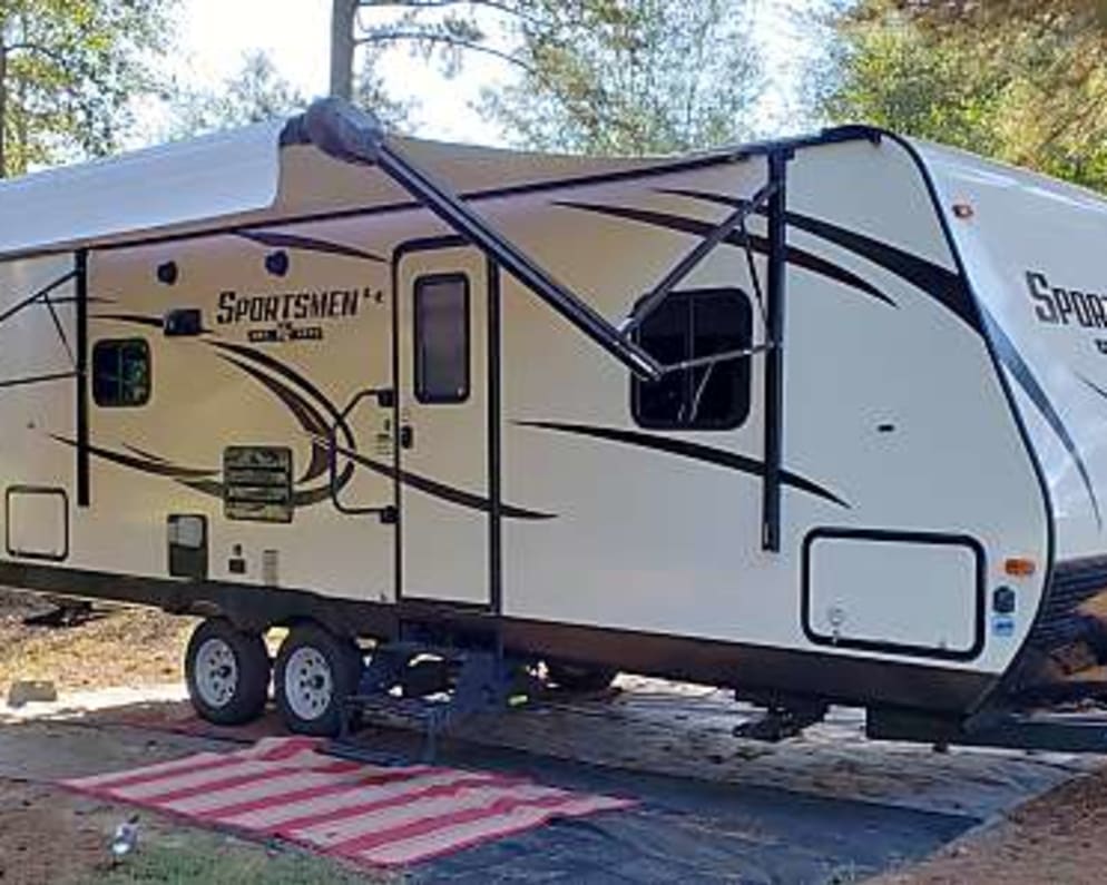 Wide Angle out side of camper with awning and &quot;porch&quot; rug out.