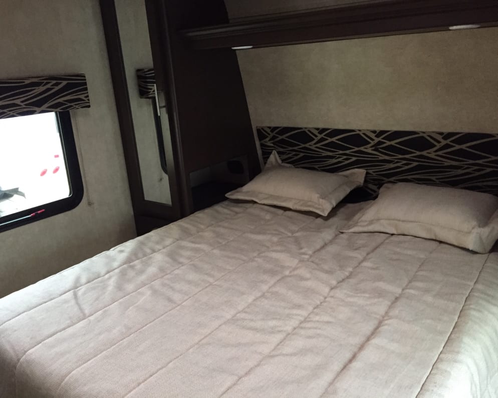 Comfy queen bed with memory foam topper. The bed is “RV length, so it’s a little shorter than a standard queen. 