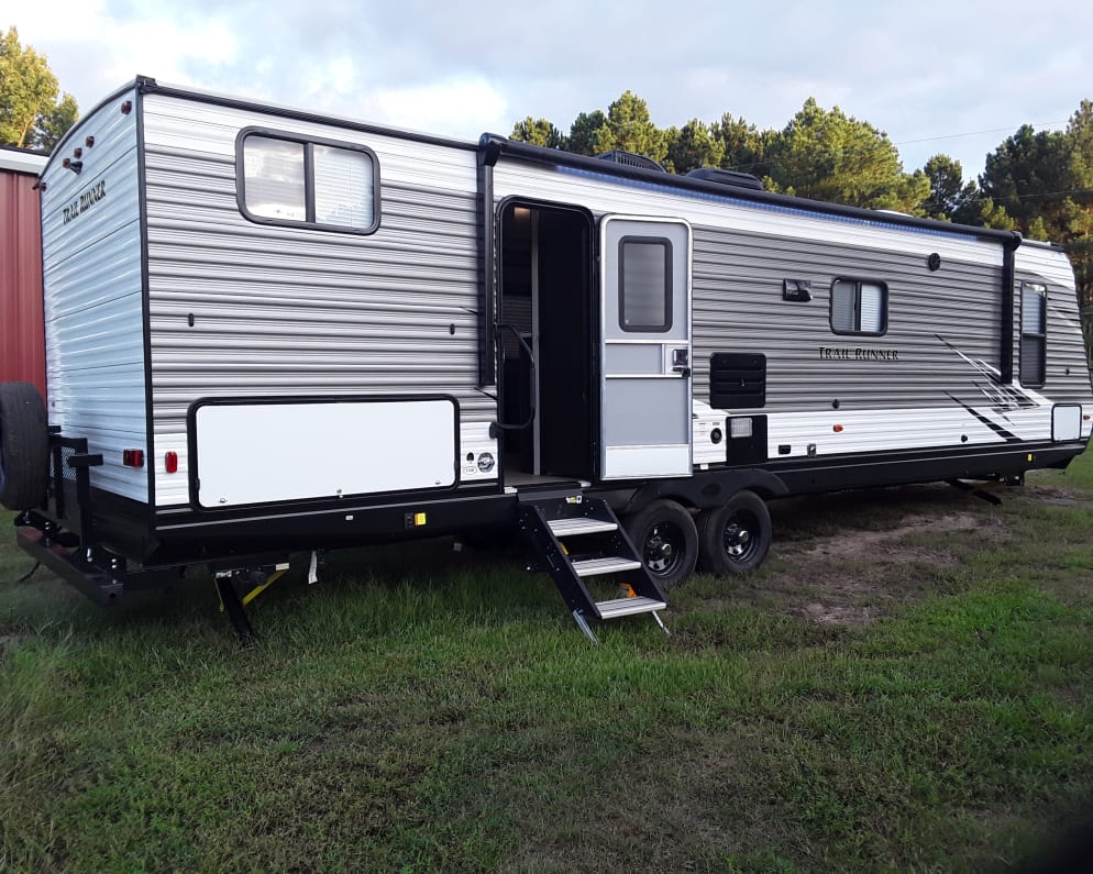 Accessorized with a 20ft awning and outdoor LED lights.