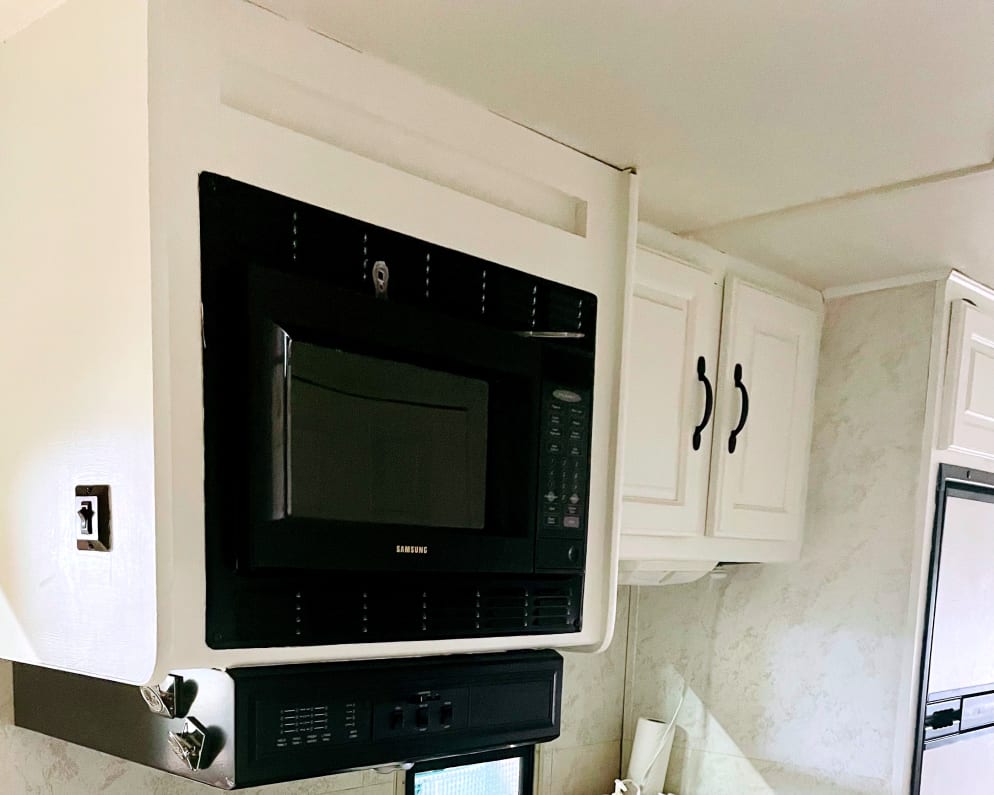 Stove with four burners, microwave, freezer and fridge.  small sink for dishes.  comes fully stocked with pots/pans and cutlery. 