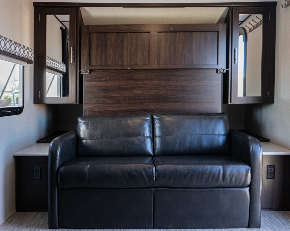 During the day enjoy lounging on a black leather couch and at night fold down the murphy bed for a very comfortable sleep (2 adults).