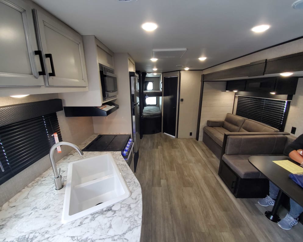 Beautiful interiors plenty of space and modern look. The dinette and knife sofa converts to beds.
50 inch TV farm look kitchen with all stainless appl