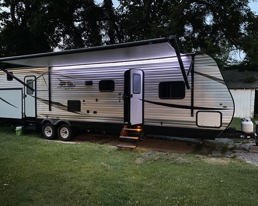 Photo shows exterior with lighted awning