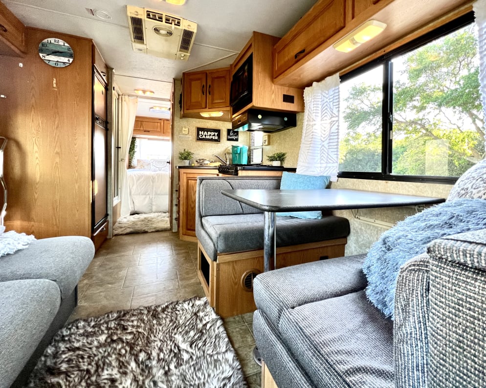 This image gives you a good idea of how well styled our rig is, showing all of the seating, dining and a glimpse of the kitchen and into the bedroom.