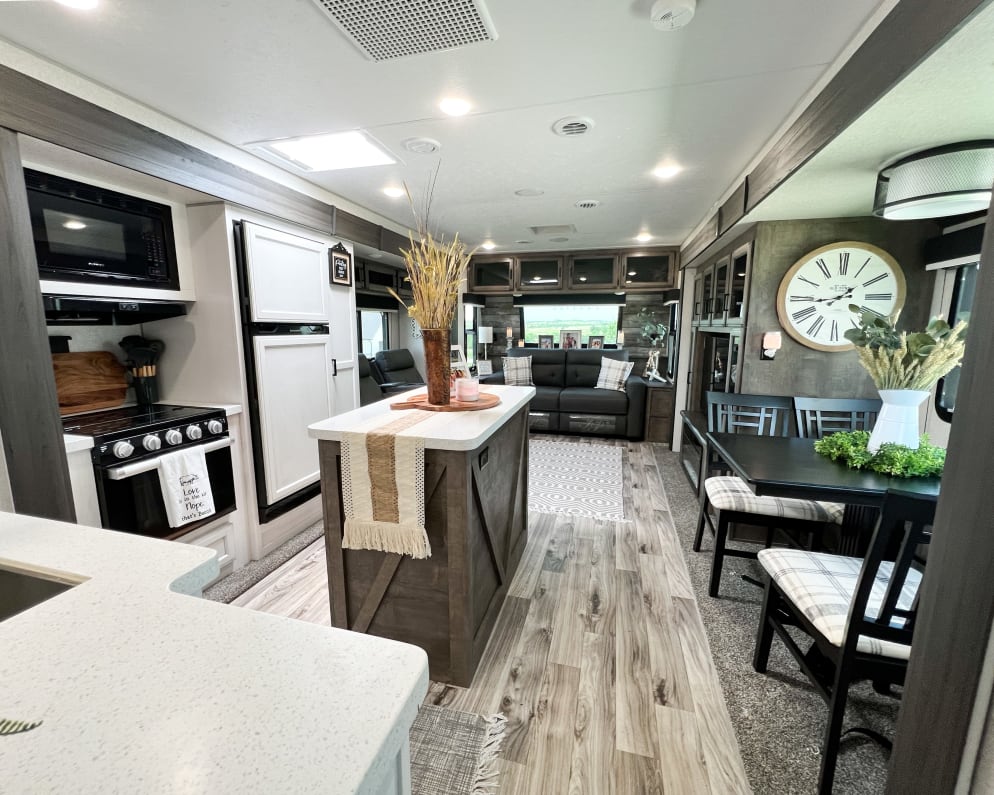 Charming luxury travel trailer with spacious and inviting open floor plan. Decorated to feel more like home.