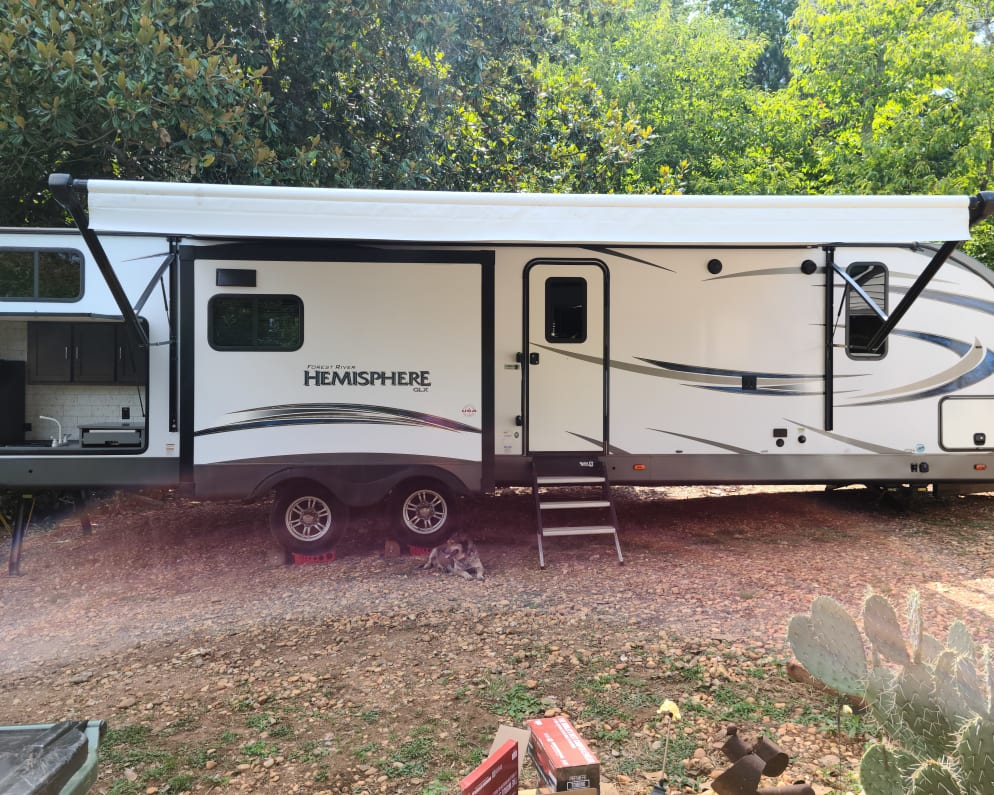 Front of camper, awning and outside kitchen