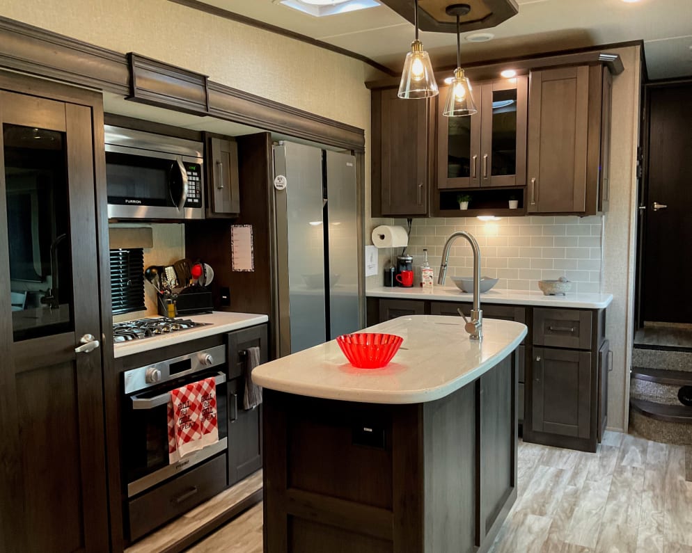 This is an exquisite cooking space. Kitchen Island with sink and lots of electrical outlets for kitchen tools and gadgets.