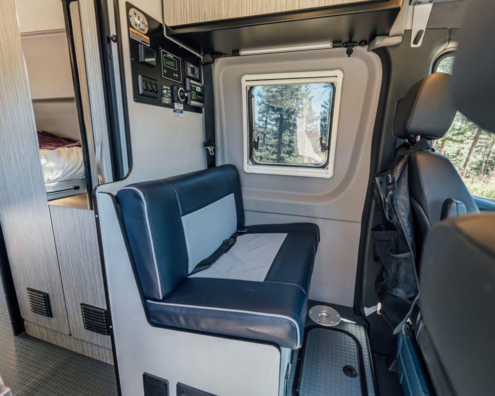 This camper van offers seating for four people and even a bathroom on board!