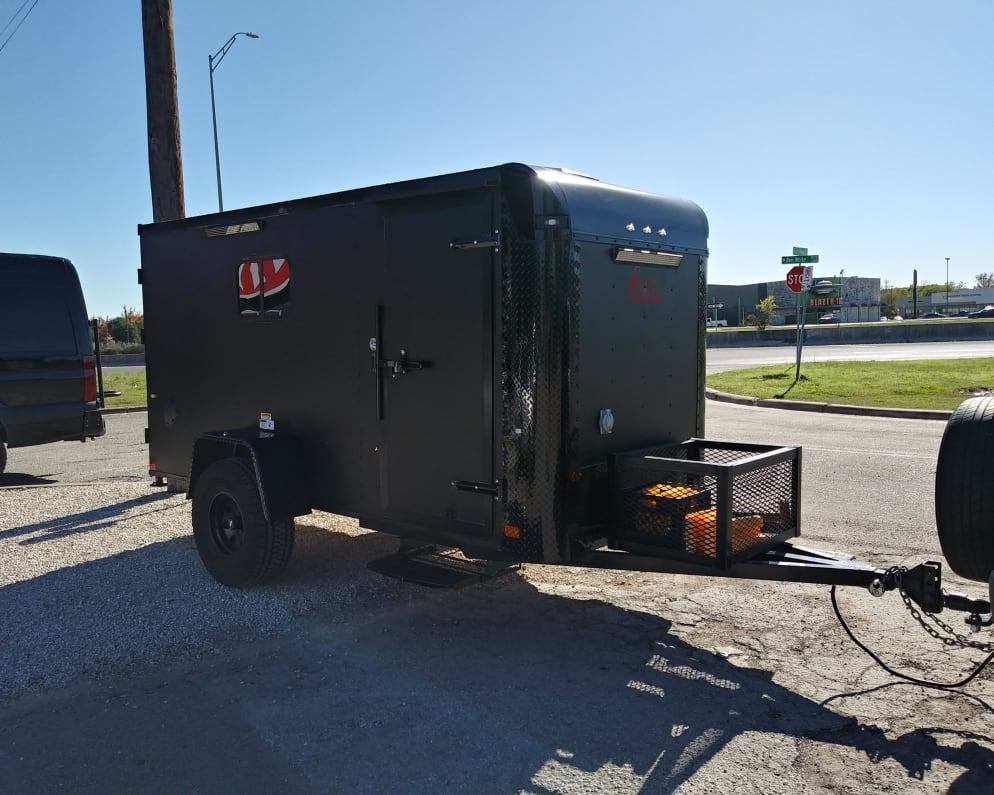 5x12 Stealth Blackout Mini Rv with a full bed and 110v hookup.  Add on include Mountain Bike, Solar Generator, and a Electric Cooking Grill.  