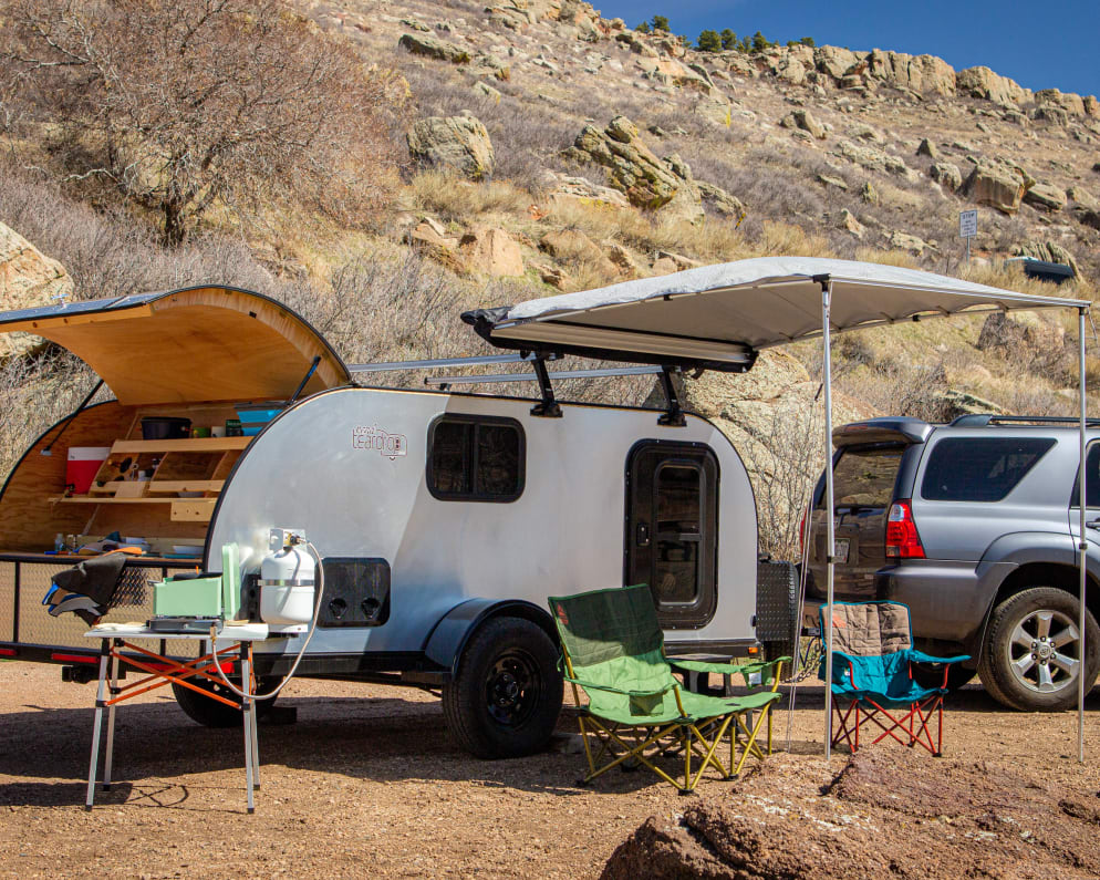 Awning, loveseat, chair, table, stove, and full propane tank all included.