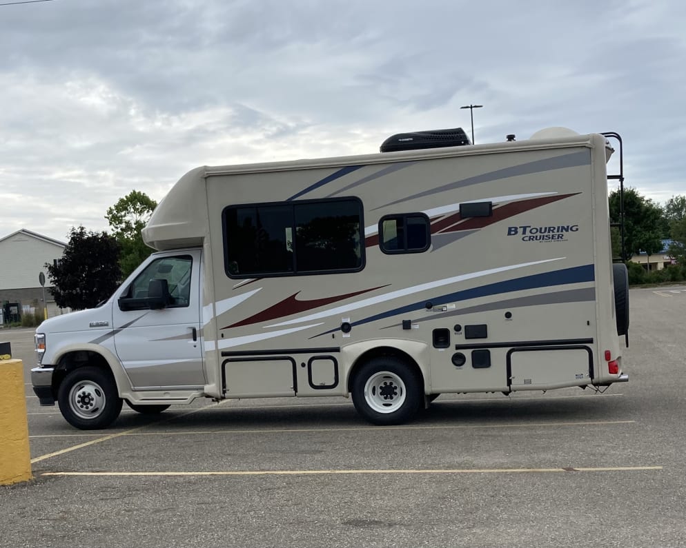 This is my actual vehicle in a parking lot. It is 22’6” and fits width wise in a standard parking space.