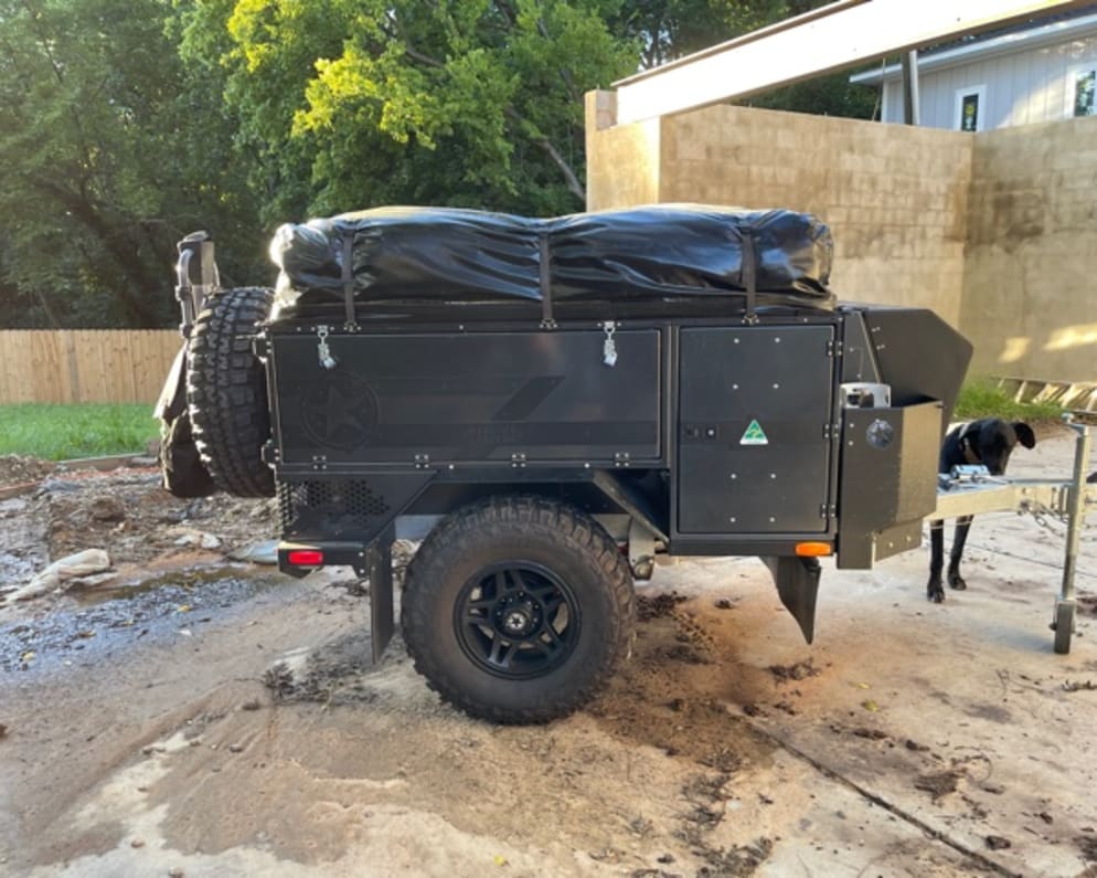 Passenger side of the trailer.  It houses the inverter, water heater, and shower hose.  