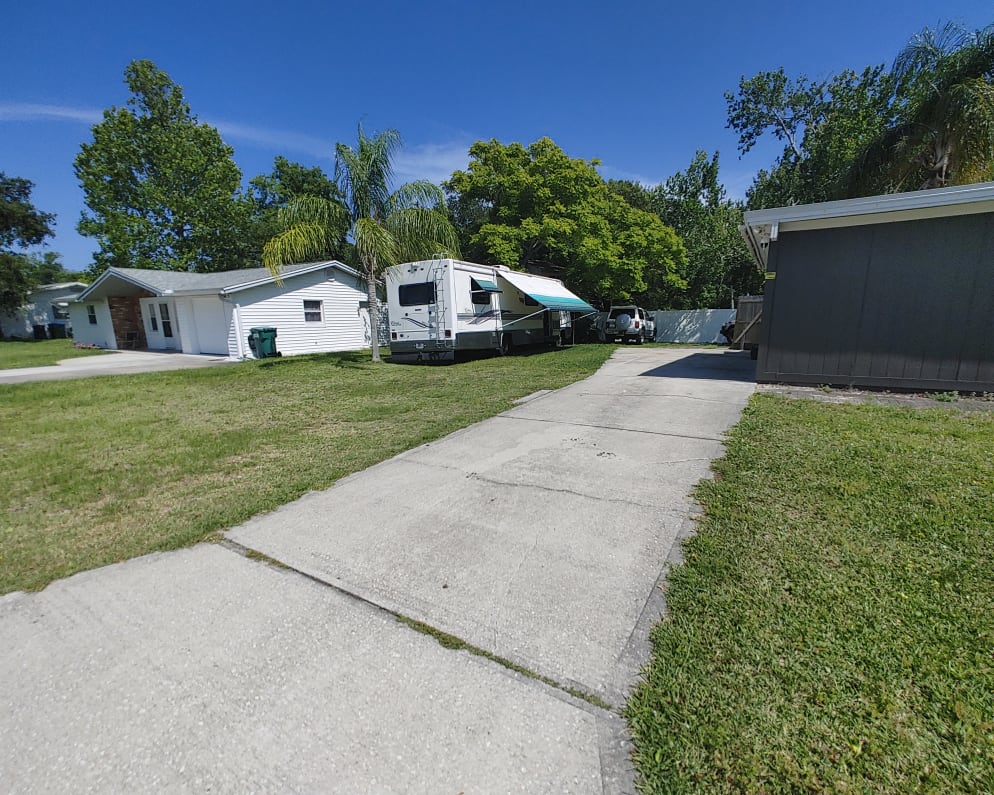 the whole grass area left of driveway is parking