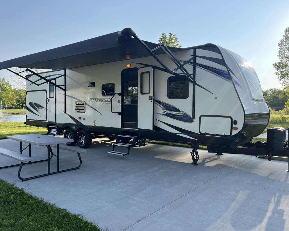 Beautiful, 35 ft, with awning, LED lighting, picnic table, located within feet of a stocked, catch and release fishing pond.