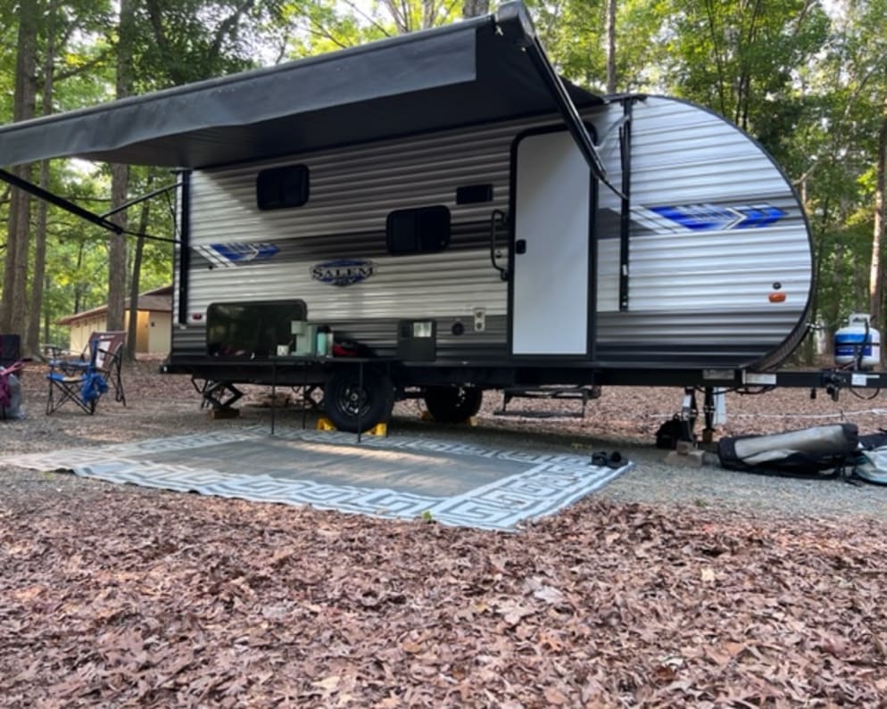 The camper comes with a camp table and a Coleman camp stove. With the outdoor electric outlet, plug in the keriug for your morning coffee.