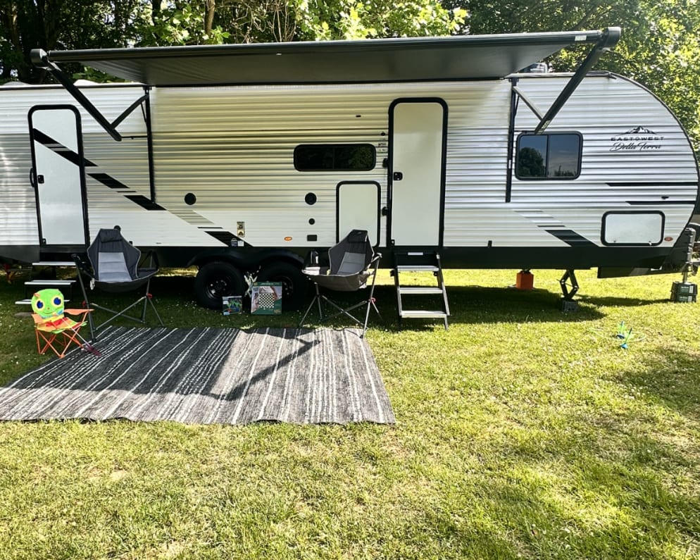 Enjoy all  the outdoors has to offer. A beautiful LED lit awning, rug,  grill, refrigerator, chairs, hammock and games are included with 2 entrances. 