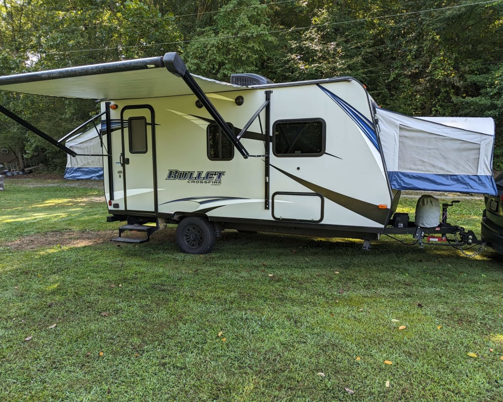 Awning fully extended, steps down, pop-outs extended, but zipped up.