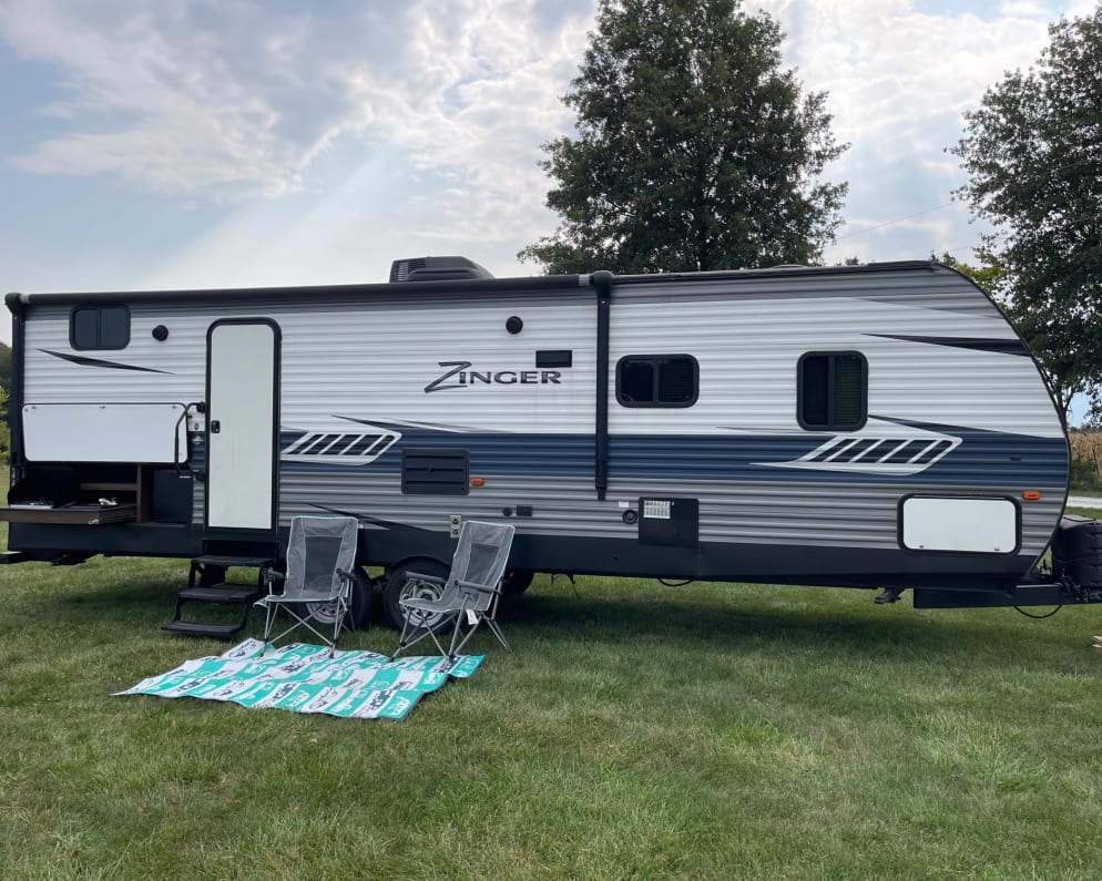 Outdoor kitchen with fridge, gas stove top, and sink. Also had automatic awning. 