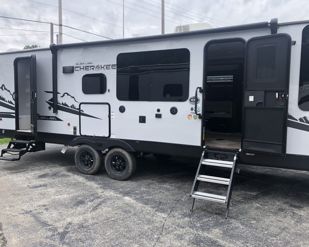 Passenger side of rig. Both entrances, outdoor kitchen, outdoor sound system. 