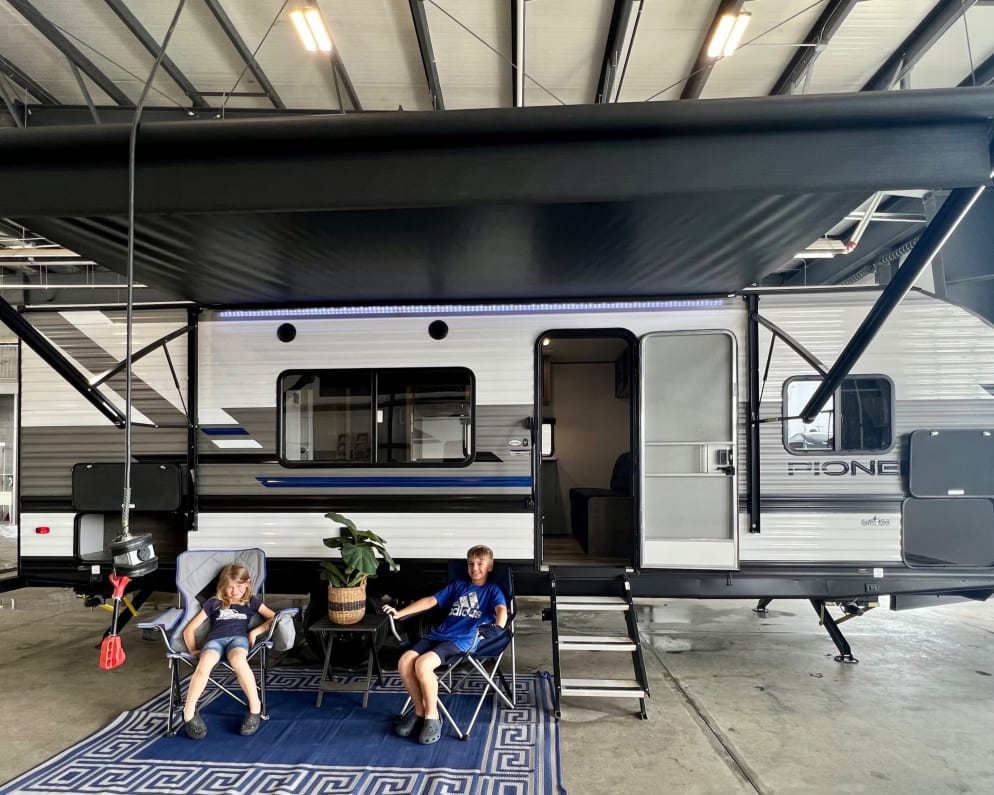 2022 Pioneer Camper full view. 

Camper has an electric awning and led lights. Camper includes walk out mats.