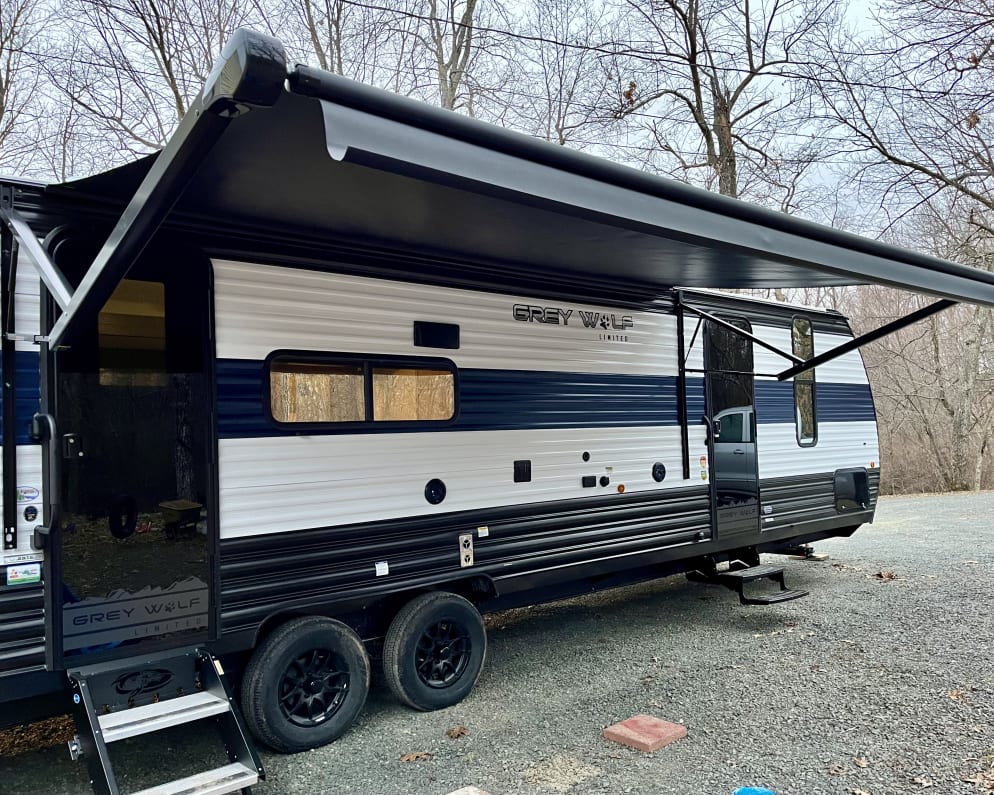 Exterior of Grey Wolf with Awning fully extended 