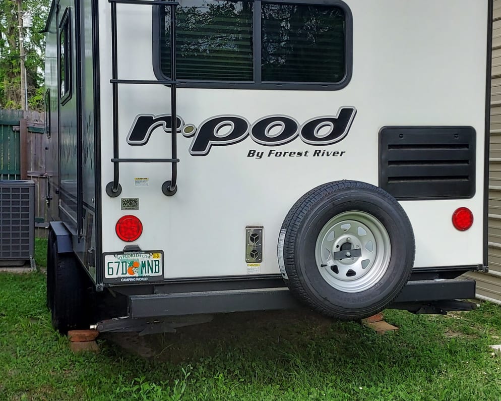 The back of the camper shows the ladder getting on the roof and the spare tire