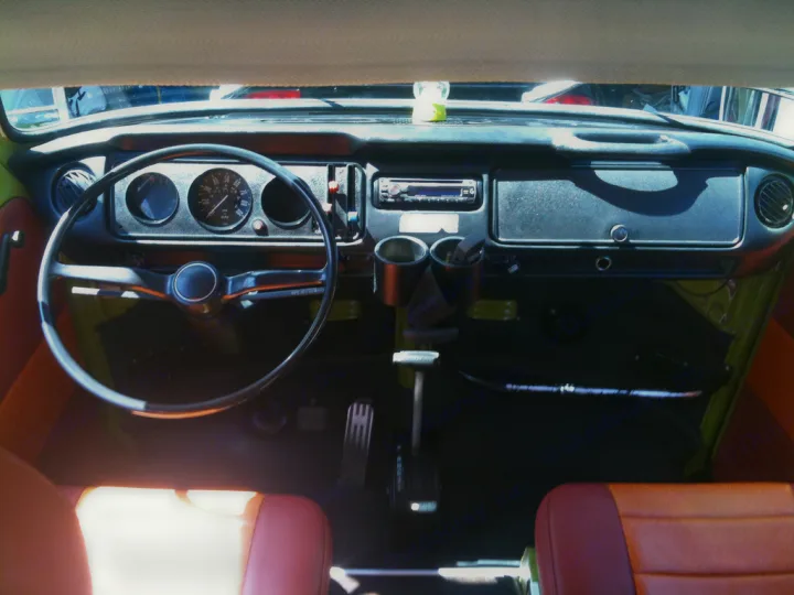 Classic VW RV rental interior: view of dashboard, steering wheel, gauges, radio, and cupholders. Adventure awaits!. Volkswagen westfalia 1979