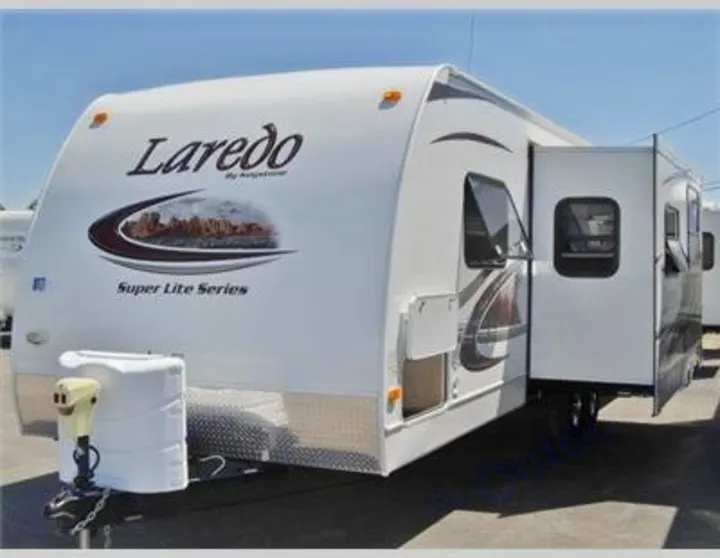 Spacious white Laredo travel trailer with a slide-out, an excellent RV rental for your next adventure.. Keystone Laredo 2012