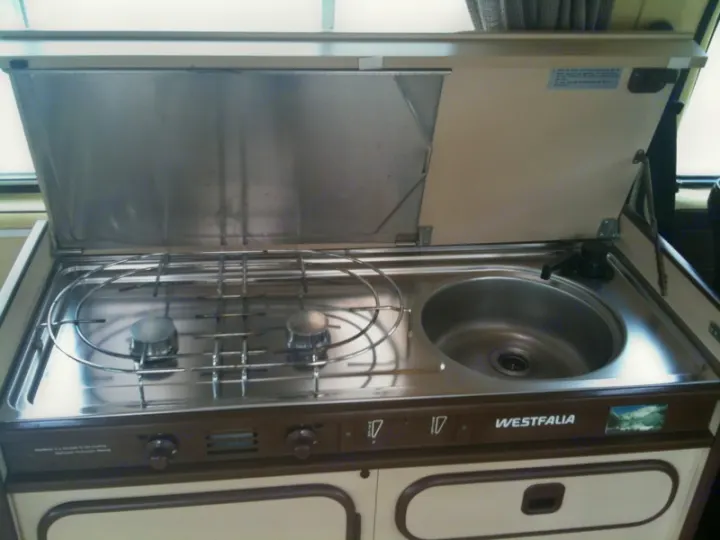 Explore with an RV rental! This Westfalia campervan kitchen offers a compact two-burner stove and sink.. Volkswagen westfalia 1984