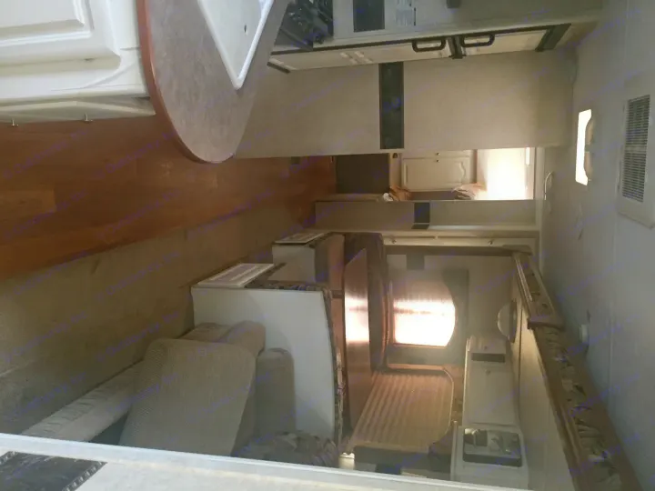 RV rental interior: Kitchen, dinette, and cozy living space visible. A hallway leads to a rear bedroom. Perfect for your next adventure.. Keystone Outback 2007