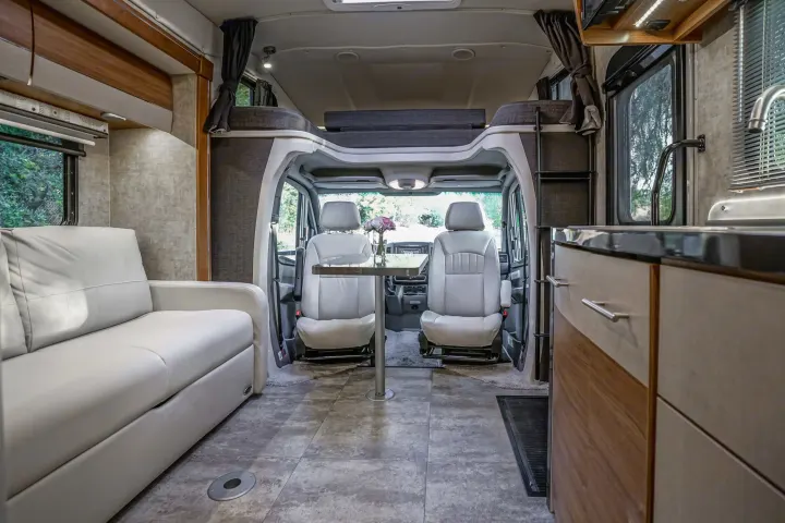 Spacious rv rental interior featuring a comfortable sofa, dining area, and kitchen. Ready for your next adventure.. Winnebago View 2016