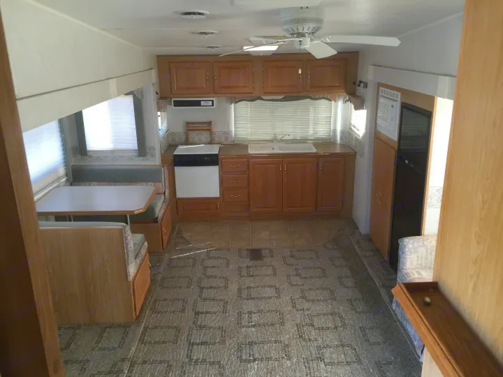 Spacious RV rental interior with a full kitchen, dinette, and ample living space. Ready for your next adventure!. Holiday Rambler Alumascape 2002