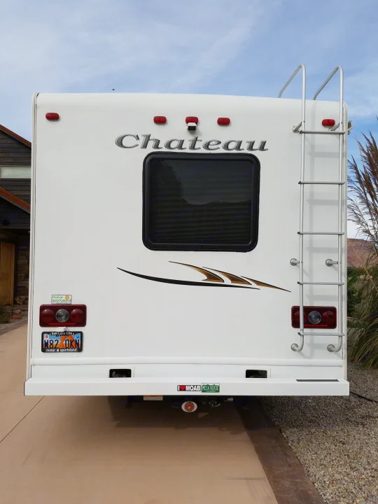 Back of a Chateau RV rental with a ladder, window, and Utah plate, ready for adventure on the road.. Thor Motor Coach Chateau 2011