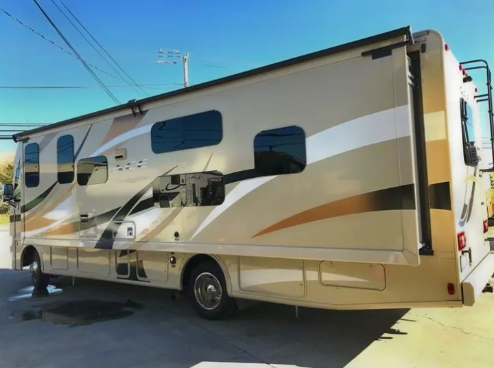 Beige Thor ACE recreational vehicle (RV) rental, parked with its side slide-out extended, ready for adventure.. THOR A.C.E 30.2 2015
