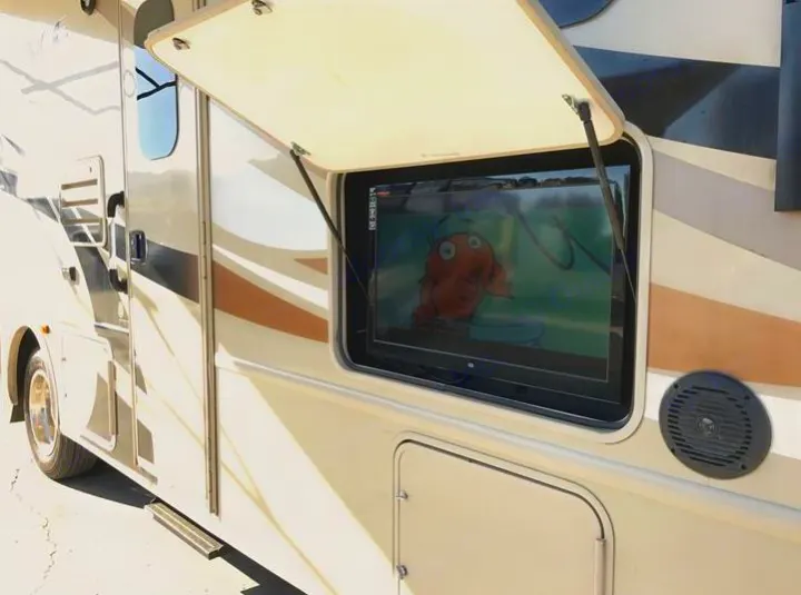 RV rental featuring an exterior TV setup, displaying an animated character (fish) with an adjacent speaker.. THOR A.C.E 30.2 2015