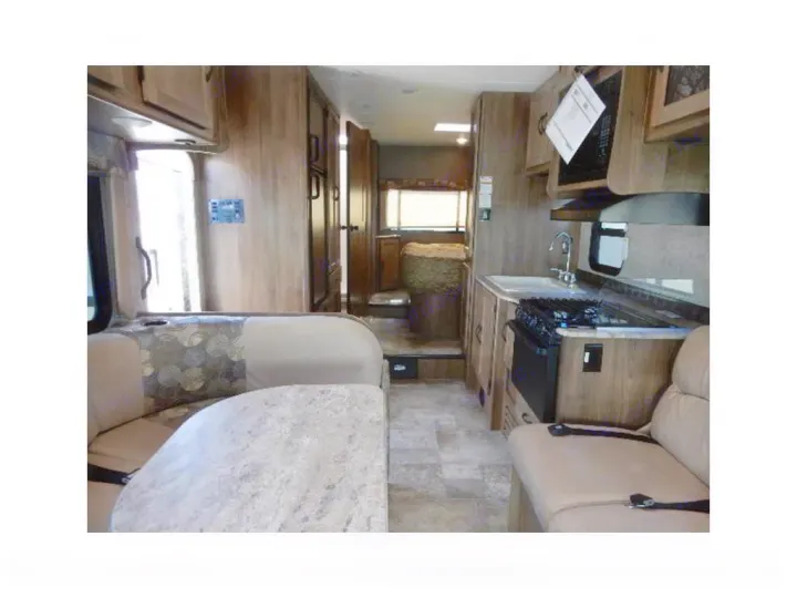 Spacious RV rental interior featuring a bright kitchen, comfortable dinette, and versatile living area.. Coachmen Freelander 2017