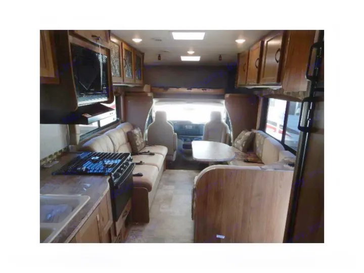 Spacious RV rental interior with kitchen, living area, and dinette, perfect for comfortable road trips.. Coachmen Freelander 2017