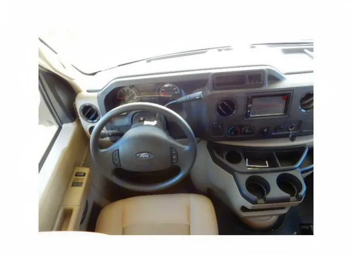 RV rental interior: driver's dashboard, Ford steering wheel, and infotainment system with cup holders. Ready for your adventure.. Coachmen Freelander 2017