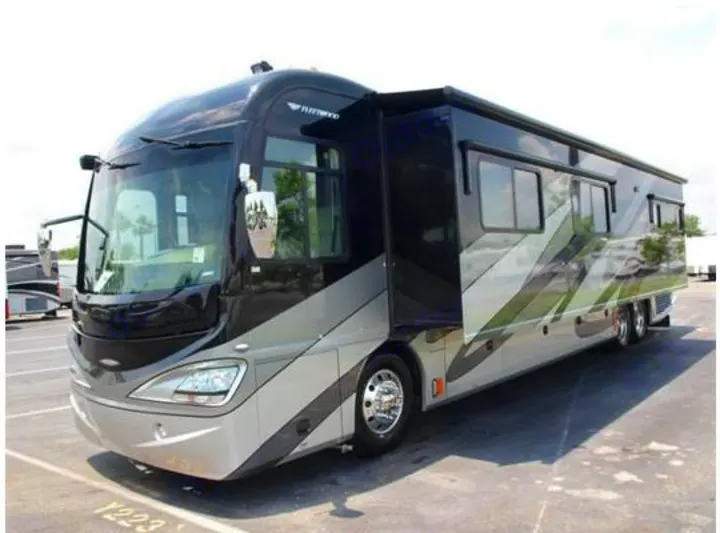 Large, luxurious black & silver motorhome, ideal for an rv rental, featuring extended slide-outs for ample space.. Fleetwood Revolution